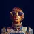 A futuristic astronaut with golden metallic details and intricate technological designs on their suit. The astronaut has a retro-style haircut and wears large reflective sunglasses that mirror a high-tech cityscape. The dark background enhances the striking gold and blue color palette of the image.